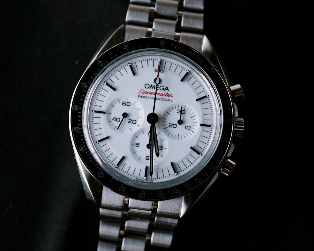 Close-up image of Omega Speedmaster Professional watch with stainless steel bracelet.